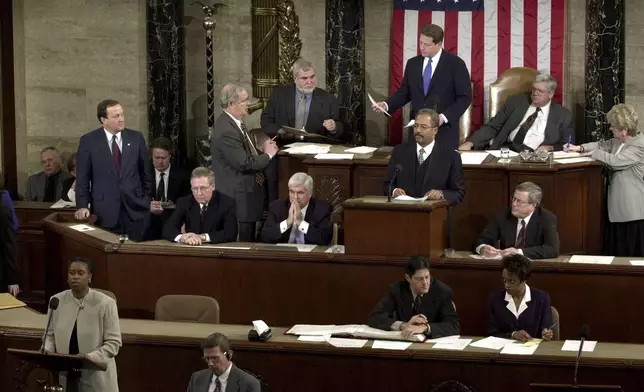 FILE - Rep. Cynthia McKinney, D-Ga., lower left, objects to Florida's electoral vote count results, as Vice President Al Gore, standing, top center, and House Speaker Dennis Hastert, R-Ill., seated, top right, listen on the floor of the U.S. House of Representatives, in Washington, Jan. 6, 2001. Other members present, seated at left in middle row are: Sen. Mitch McConnell, R-Ky., Chris Dodd, D-Ct, hand over mouth., Chaka Fattah, D-Pa., standing at podium and Rep. William Thomas, R-Calif. Others not identified. (AP Photo/Kenneth Lambert, File)