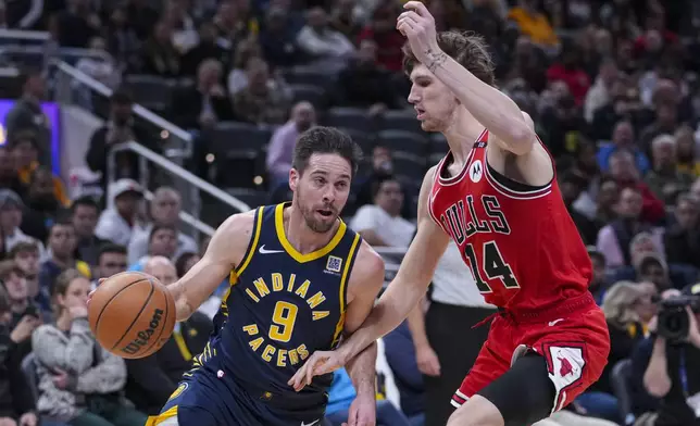 Indiana Pacers guard T.J. McConnell (9) drives around Chicago Bulls forward Matas Buzelis (14) during the first half of an NBA basketball game in Indianapolis, Wednesday, Jan. 8, 2025. (AP Photo/Michael Conroy)