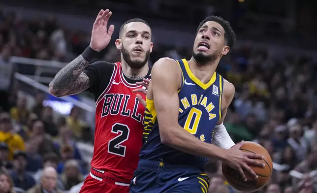 Indiana Pacers guard Tyrese Haliburton (0) looks to shoot over Chicago Bulls guard Lonzo Ball (2) during the first half of an NBA basketball game in Indianapolis, Wednesday, Jan. 8, 2025. (AP Photo/Michael Conroy)