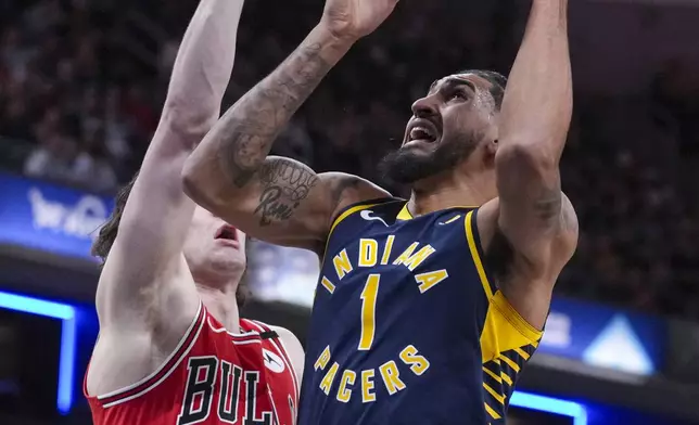 Indiana Pacers forward Obi Toppin (1) shoots over Chicago Bulls guard Josh Giddey (3) during the first half of an NBA basketball game in Indianapolis, Wednesday, Jan. 8, 2025. (AP Photo/Michael Conroy)