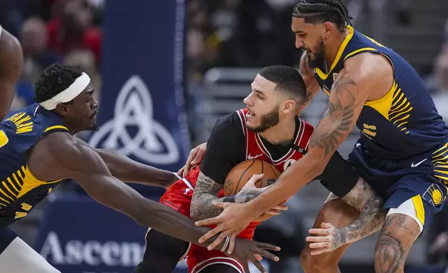 Chicago Bulls guard Lonzo Ball (2) is trapped by Indiana Pacers forward Pascal Siakam (43) and forward Obi Toppin (1) during the first half of an NBA basketball game in Indianapolis, Wednesday, Jan. 8, 2025. (AP Photo/Michael Conroy)