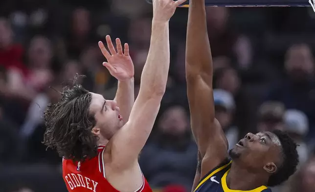 Indiana Pacers center Thomas Bryant (3) blocks the shot of Chicago Bulls guard Josh Giddey (3) during the first half of an NBA basketball game in Indianapolis, Wednesday, Jan. 8, 2025. (AP Photo/Michael Conroy)