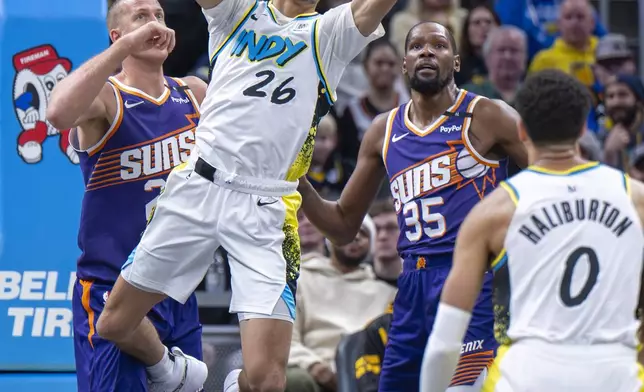 Indiana Pacers guard Ben Sheppard (26) reaches for a rebound during the first half of an NBA basketball game against the Phoenix Suns in Indianapolis, Saturday, Jan. 4, 2025. (AP Photo/Doug McSchooler)