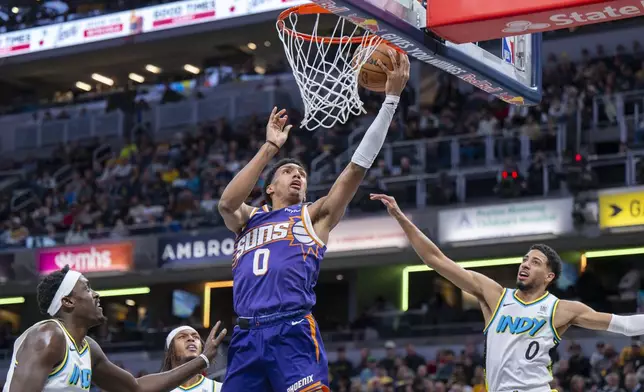 Phoenix Suns forward Ryan Dunn (0) shoots during the first half of an NBA basketball game against the Indiana Pacers in Indianapolis, Saturday, Jan. 4, 2025. (AP Photo/Doug McSchooler)