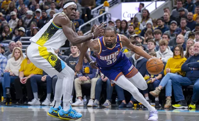 Phoenix Suns forward Kevin Durant (35) makes a move along the baseline while being defended by Indiana Pacers forward Pascal Siakam, left, during the first half of an NBA basketball game in Indianapolis, Saturday, Jan. 4, 2025. (AP Photo/Doug McSchooler)