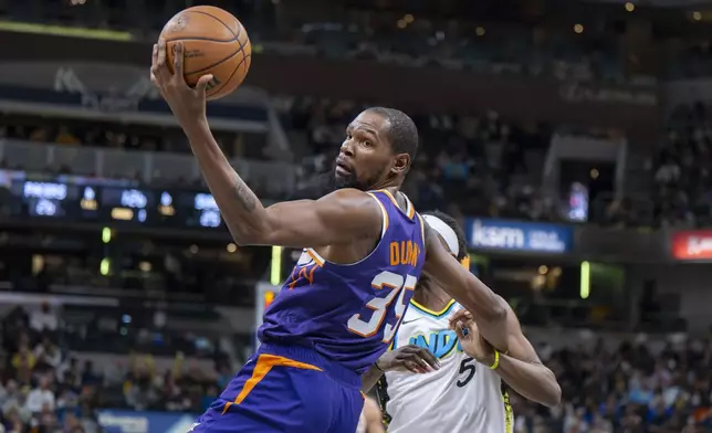 Phoenix Suns forward Kevin Durant (35) pulls in a pass during the first half of an NBA basketball game against the Indiana Pacers in Indianapolis, Saturday, Jan. 4, 2025. (AP Photo/Doug McSchooler)