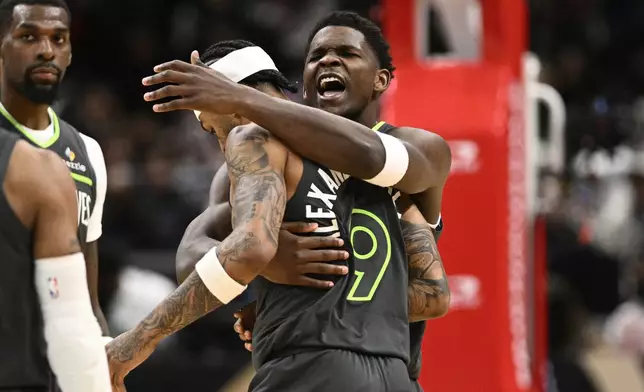 Minnesota Timberwolves guard Anthony Edwards, right, reacts with guard Nickeil Alexander-Walker (9) after Alexander-Walker made a 3-point basket during the second half of an NBA basketball game against the Washington Wizards, Monday, Jan. 13, 2025, in Washington. (AP Photo/Nick Wass)