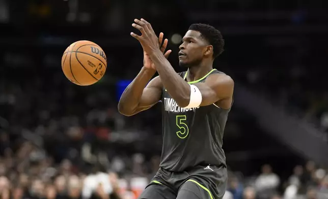 Minnesota Timberwolves guard Anthony Edwards loses his grip on the ball during the first half of an NBA basketball game against the Washington Wizards, Monday, Jan. 13, 2025, in Washington. (AP Photo/Nick Wass)