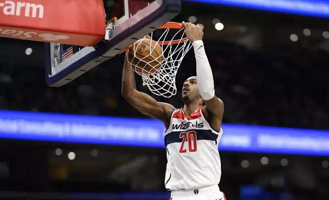 Washington Wizards forward Alexandre Sarr dunks during the second half of an NBA basketball game against the Minnesota Timberwolves, Monday, Jan. 13, 2025, in Washington. (AP Photo/Nick Wass)