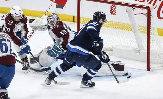 Winnipeg Jets' Kyle Connor's (81) shot goes off the post as Colorado Avalanche goaltender Mackenzie Blackwood (39) stretches during second period NHL action in Winnipeg on Saturday, Jan. 11, 2025. (John Woods/The Canadian Press via AP)
