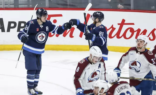 Winnipeg Jets' Mark Scheifele (55) and Kyle Connor (81) celebrate Scheifele's goal against the Colorado Avalanche during second period NHL action in Winnipeg on Saturday, January 11, 2025. (John Woods/The Canadian Press via AP)