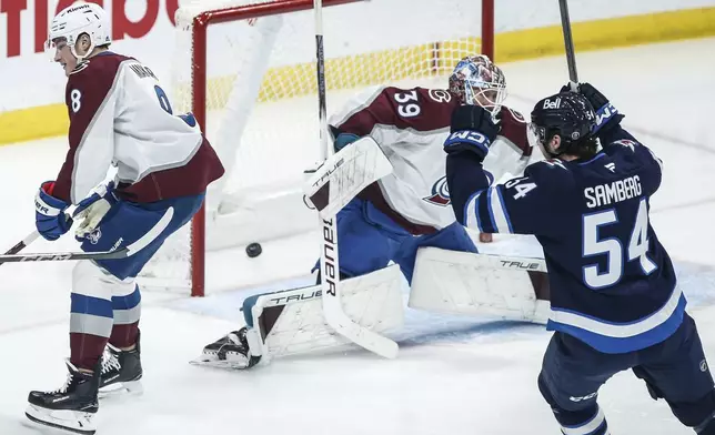 Winnipeg Jets' Dylan Samberg (54) celebrates Nikolaj Ehlers' (not shown) goal against Colorado Avalanche goaltender Mackenzie Blackwood (39) during first period NHL action in Winnipeg on Saturday, Jan. 11, 2025. (John Woods/The Canadian Press via AP)
