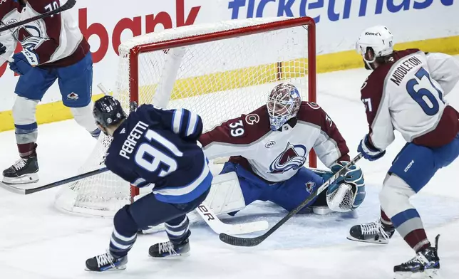 Winnipeg Jets' Dylan Samberg (54) celebrates Nikolaj Ehlers' (not shown) goal against Colorado Avalanche goaltender Mackenzie Blackwood (39) during first period NHL action in Winnipeg on Saturday, Jan. 11, 2025. (John Woods/The Canadian Press via AP)