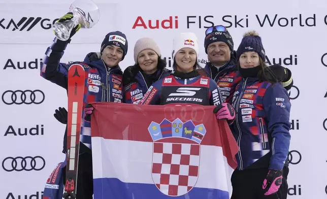 The winner Croatia's Zrinka Ljutic celebrates with her team after an alpine ski, women's World Cup slalom race, in Kranjska Gora, Slovenia, Sunday, Jan. 5, 2025. (AP Photo/Piermarco Tacca)