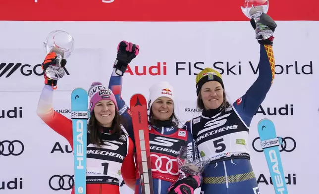 From left, second placed Switzerland's Wendy Holdener, the winner Croatia's Zrinka Ljutic and third placed Sweden's Anna Swenn Larsson celebrate after an alpine ski, women's World Cup slalom race, in Kranjska Gora, Slovenia, Sunday, Jan. 5, 2025. (AP Photo/Piermarco Tacca)