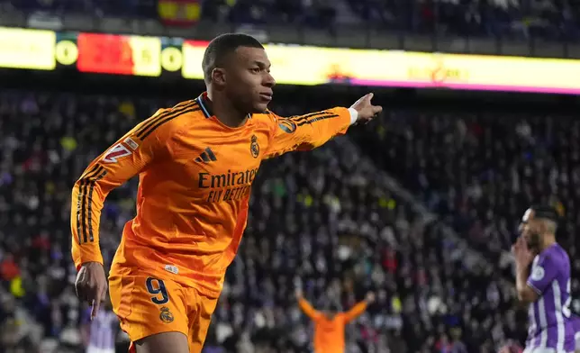 Real Madrid's Kylian Mbappe celebrates after scoring his side's first goal during the Spanish La Liga soccer match between Valladolid and Real Madrid at the Jose Zorrilla stadium in Valladolid, Spain, Saturday, Jan. 25, 2025. (AP Photo/Manu Fernandez)