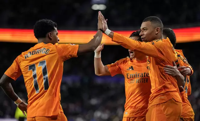 Real Madrid's Kylian Mbappe celebrates after scoring his side's second goal during the Spanish La Liga soccer match between Valladolid and Real Madrid at the Jose Zorrilla stadium in Valladolid, Spain, Saturday, Jan. 25, 2025. (AP Photo/Manu Fernandez)