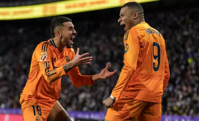 Real Madrid's Kylian Mbappe celebrates after scoring his side's second goal during the Spanish La Liga soccer match between Valladolid and Real Madrid at the Jose Zorrilla stadium in Valladolid, Spain, Saturday, Jan. 25, 2025. (AP Photo/Manu Fernandez)