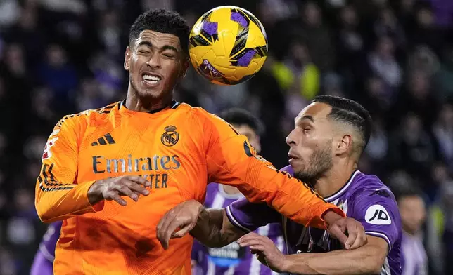 Real Madrid's Jude Bellingham, left, heads for the ball next to Valladolid's Anuar during the Spanish La Liga soccer match between Valladolid and Real Madrid at the Jose Zorrilla stadium in Valladolid, Spain, Saturday, Jan. 25, 2025. (AP Photo/Manu Fernandez)