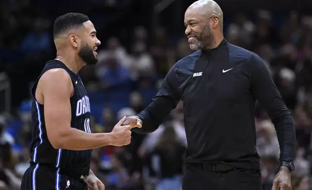 Orlando Magic head coach Jamahl Mosley, right, talks with guard Cory Joseph, left, during the first half of an NBA basketball game against the Utah Jazz, Sunday, Jan. 5, 2025, in Orlando, Fla. (AP Photo/Phelan M. Ebenhack)