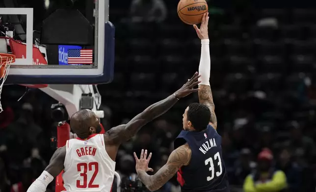 Washington Wizards forward Kyle Kuzma (33) shoots against Houston Rockets forward Jeff Green (32) during the first half of an NBA basketball game Tuesday, Jan. 7, 2025, in Washington. (AP Photo/Jess Rapfogel)