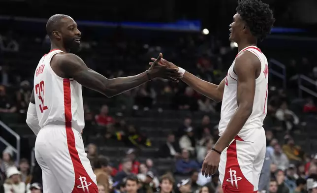 Houston Rockets forwards Jeff Green (32) and Amen Thompson (1) high five after scoring against the Washington Wizards during the first half of an NBA basketball game Tuesday, Jan. 7, 2025, in Washington. (AP Photo/Jess Rapfogel)