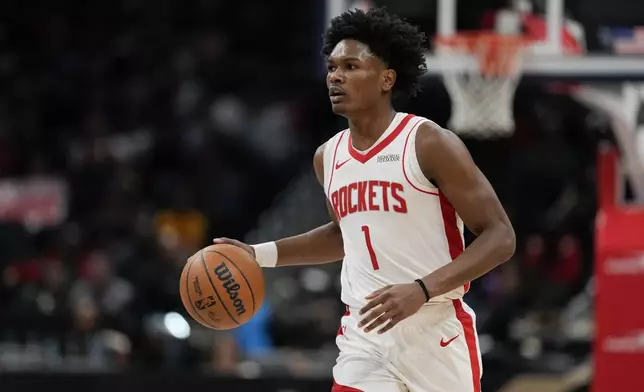 Houston Rockets forward Amen Thompson dribbles the ball down the court during the first half of an NBA basketball game against the Washington Wizards, Tuesday, Jan. 7, 2025, in Washington. (AP Photo/Jess Rapfogel)