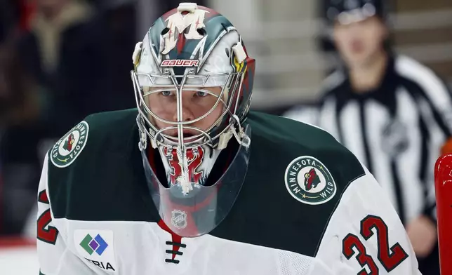 Minnesota Wild goaltender Filip Gustavsson (32) watches the puck against the Carolina Hurricanes during the second period of an NHL hockey game in Raleigh, N.C., Saturday, Jan. 4, 2025. (AP Photo/Karl DeBlaker)