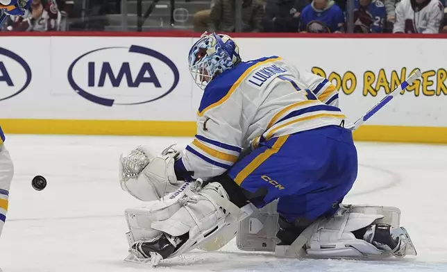 Buffalo Sabres goaltender Ukko-Pekka Luukkonen looks to make a glove save in the first period of an NHL hockey game against the Colorado Avalanche Thursday, Jan. 2, 2025, in Denver. (AP Photo/David Zalubowski)