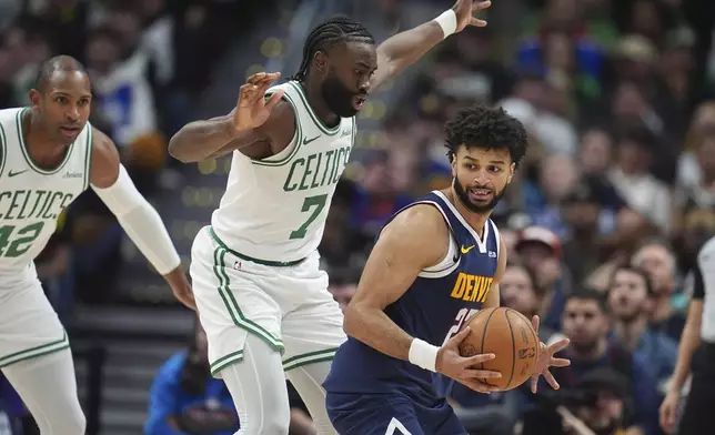 Denver Nuggets guard Jamal Murray, right, gets trapped with the ball by Boston Celtics guard Jaylen Brown and center Al Horford, left, in the first half of an NBA basketball game Tuesday, Jan. 7, 2025, in Denver. (AP Photo/David Zalubowski)