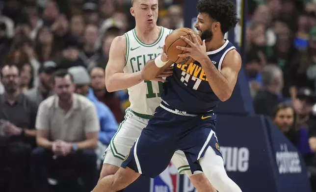 Denver Nuggets guard Jamal Murray, front, gets trapped with the ball by Boston Celtics guard Payton Pritchard in the first half of an NBA basketball game, Tuesday, Jan. 7, 2025, in Denver. (AP Photo/David Zalubowski)