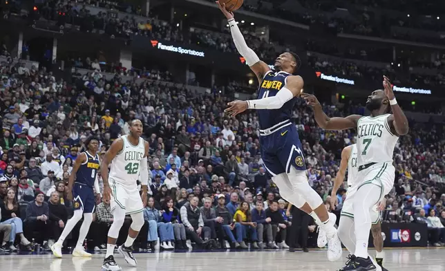 Denver Nuggets guard Russell Westbrook, center, drives to the basket past Boston Celtics guard Jaylen Brown, right, and center Al Horford in the second half of an NBA basketball game Tuesday, Jan. 7, 2025, in Denver. (AP Photo/David Zalubowski)