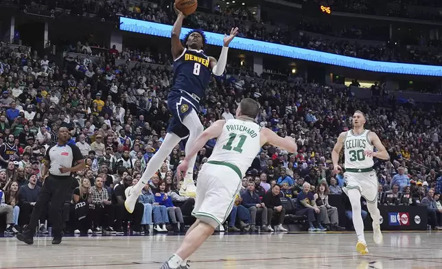 Denver Nuggets forward Peyton Watson (8) goes up for a basket as Boston Celtics guard Payton Pritchard (11) and forward Sam Hauser (30) defend in the second half of an NBA basketball game Tuesday, Jan. 7, 2025, in Denver. (AP Photo/David Zalubowski)