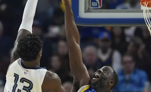 Memphis Grizzlies forward Jaren Jackson Jr., left, shoots over Golden State Warriors forward Draymond Green, right, during the first half of an NBA basketball game Saturday, Jan. 4, 2025, in San Francisco. (AP Photo/Godofredo A. Vásquez)