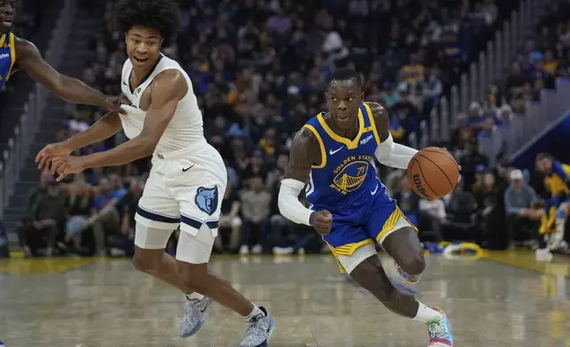 Golden State Warriors guard Dennis Schröder, right, moves the ball next to Memphis Grizzlies forward Jaylen Wells, left, during the first half of an NBA basketball game Saturday, Jan. 4, 2025, in San Francisco. (AP Photo/Godofredo A. Vásquez)