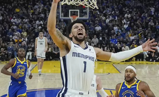 Memphis Grizzlies guard Scotty Pippen Jr. (1) is fouled by Golden State Warriors guard Lindy Waters III, bottom, during the first half of an NBA basketball game Saturday, Jan. 4, 2025, in San Francisco. (AP Photo/Godofredo A. Vásquez)