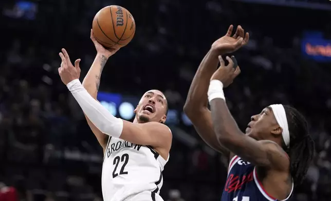 Brooklyn Nets forward Jalen Wilson, left, shoots as Los Angeles Clippers guard Terance Mann defends during the first half of an NBA basketball game, Wednesday, Jan. 15, 2025, in Inglewood, Calif. (AP Photo/Mark J. Terrill)