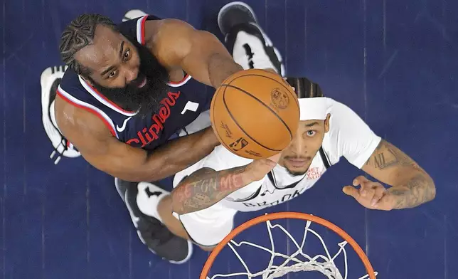 Los Angeles Clippers guard James Harden, left, and Brooklyn Nets guard Keon Johnson go after a rebound during the first half of an NBA basketball game, Wednesday, Jan. 15, 2025, in Inglewood, Calif. (AP Photo/Mark J. Terrill)