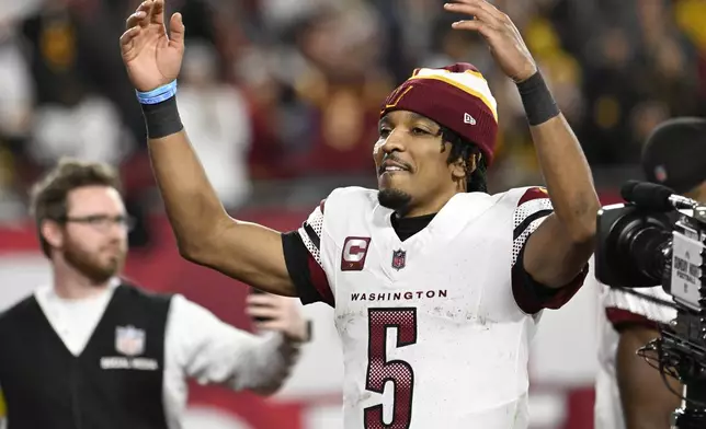 Washington Commanders quarterback Jayden Daniels (5) celebrates after an NFL wild-card playoff football game against the Tampa Bay Buccaneers in Tampa, Fla., Sunday, Jan. 12, 2025. (AP Photo/Jason Behnken)
