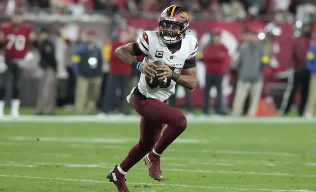 Washington Commanders quarterback Jayden Daniels (5) scrambles out of the pocket against the Tampa Bay Buccaneers during the first half of an NFL wild-card playoff football game in Tampa, Fla., Sunday, Jan. 12, 2025. (AP Photo/Chris O'Meara)