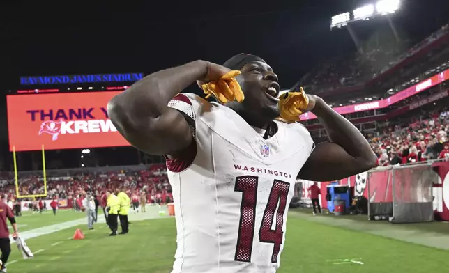 Washington Commanders wide receiver Olamide Zaccheaus (14) celebrates after an NFL wild-card playoff football game against the Tampa Bay Buccaneers in Tampa, Fla., Sunday, Jan. 12, 2025. (AP Photo/Jason Behnken)