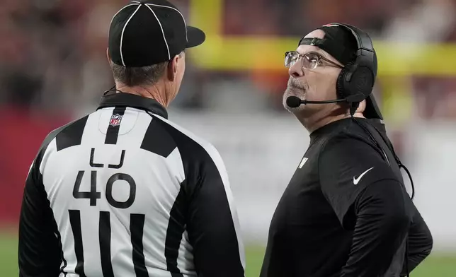 Washington Commanders head coach Dan Quinn, right, reacts toward line judge Brian Bolinger (40) during the second half of an NFL wild-card playoff football game against the Tampa Bay Buccaneers in Tampa, Fla., Sunday, Jan. 12, 2025. (AP Photo/Chris O'Meara)