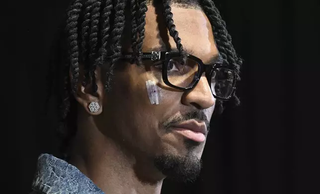 Washington Commanders quarterback Jayden Daniels speaks at a news conference after an NFL wild-card playoff football game against the Tampa Bay Buccaneers in Tampa, Fla., Sunday, Jan. 12, 2025. (AP Photo/Jason Behnken)