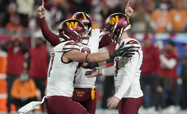 Washington Commanders place kicker Zane Gonzalez, right, is congratulated by teammates after kicking the game winning field goal against the Tampa Bay Buccaneers during the second half of an NFL wild-card playoff football game in Tampa, Fla., Sunday, Jan. 12, 2025. (AP Photo/Chris O'Meara)