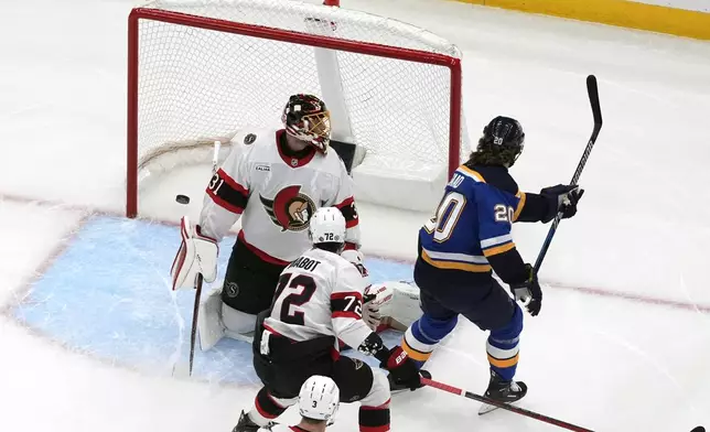 St. Louis Blues' Brandon Saad (20) scores past Ottawa Senators goaltender Anton Forsberg (31) and Thomas Chabot (72) during the first period of an NHL hockey game Friday, Jan. 3, 2025, in St. Louis. (AP Photo/Jeff Roberson)