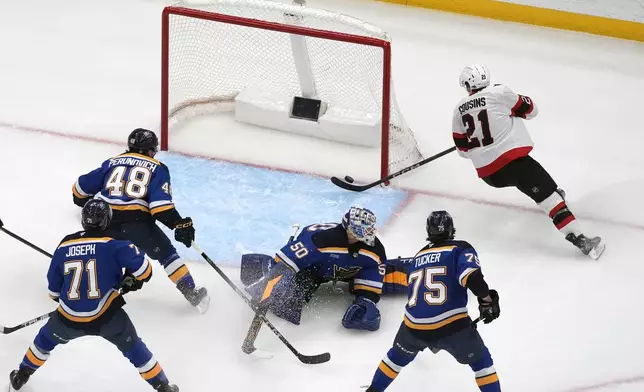 Ottawa Senators' Nick Cousins (21) is unable to score past St. Louis Blues goaltender Jordan Binnington (50) during the second period of an NHL hockey game Friday, Jan. 3, 2025, in St. Louis. (AP Photo/Jeff Roberson)