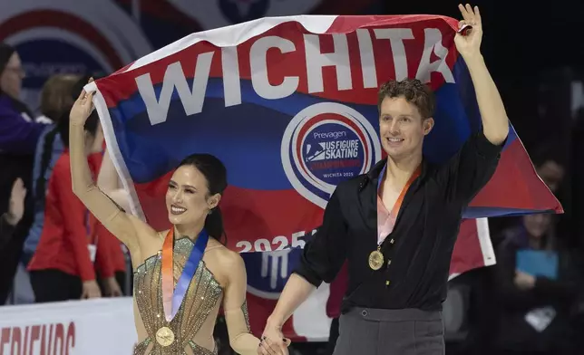 Madison Chock, left, and Evan Bates, right, acknowledge the crowd after winning the ice dance competition at the U.S. figure skating championships Saturday, Jan. 25, 2025, in Wichita, Kan. (AP Photo/Travis Heying)