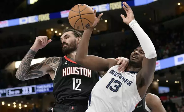 Houston Rockets center Steven Adams (12) and Memphis Grizzlies forward Jaren Jackson Jr. (13) move for position in the first half of an NBA basketball game Thursday, Jan. 9, 2025, in Memphis, Tenn. (AP Photo/Brandon Dill)