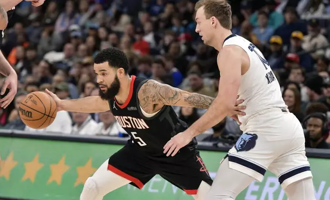 Houston Rockets guard Fred VanVleet (5) handles the ball against Memphis Grizzlies guard Luke Kennard in the first half of an NBA basketball game, Thursday, Jan. 9, 2025, in Memphis, Tenn. (AP Photo/Brandon Dill)