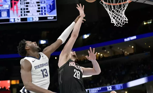 Houston Rockets center Alperen Sengun (28) shoots ahead of Memphis Grizzlies forward Jaren Jackson Jr. (13) in the first half of an NBA basketball game, Thursday, Jan. 9, 2025, in Memphis, Tenn. (AP Photo/Brandon Dill)